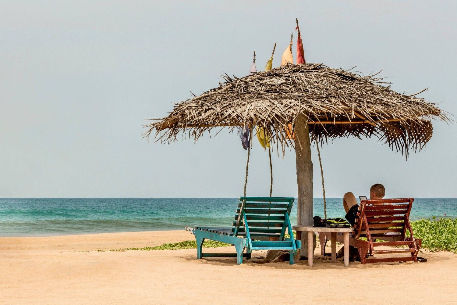 A Man Is Relaxing On Bentota Beach In Sri Lanka