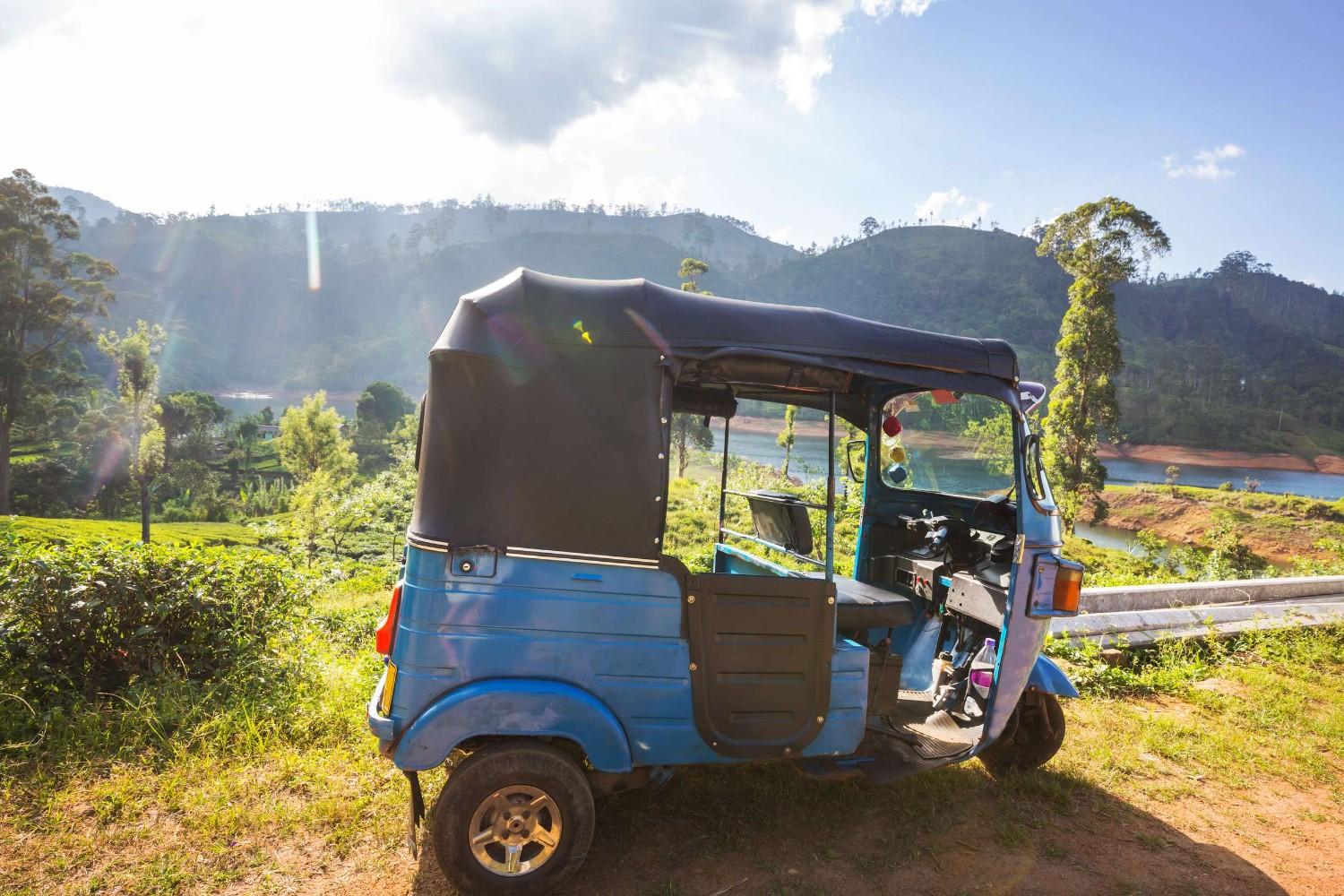 A Tuk Tuk Parked Near A Tea Plantation