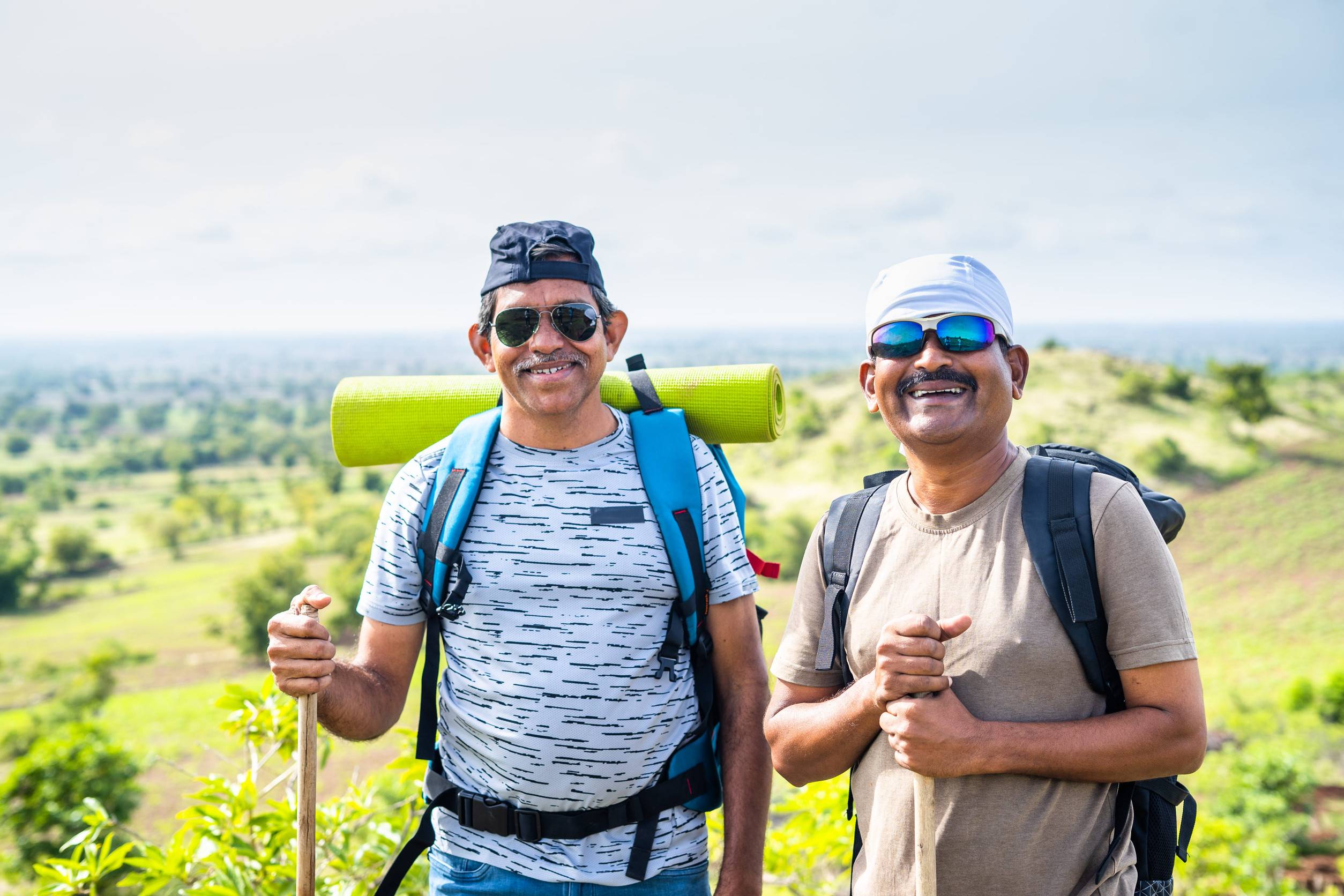 Two old friends trekking beside a mountain